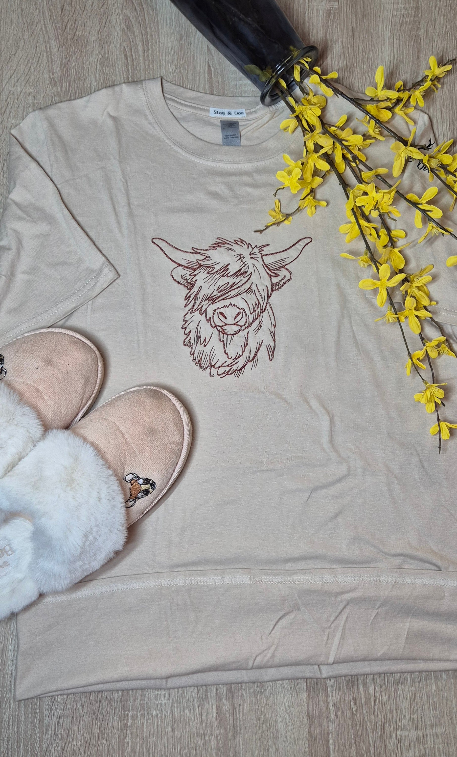 Beige short-sleeve t-shirt with a highland  cow design