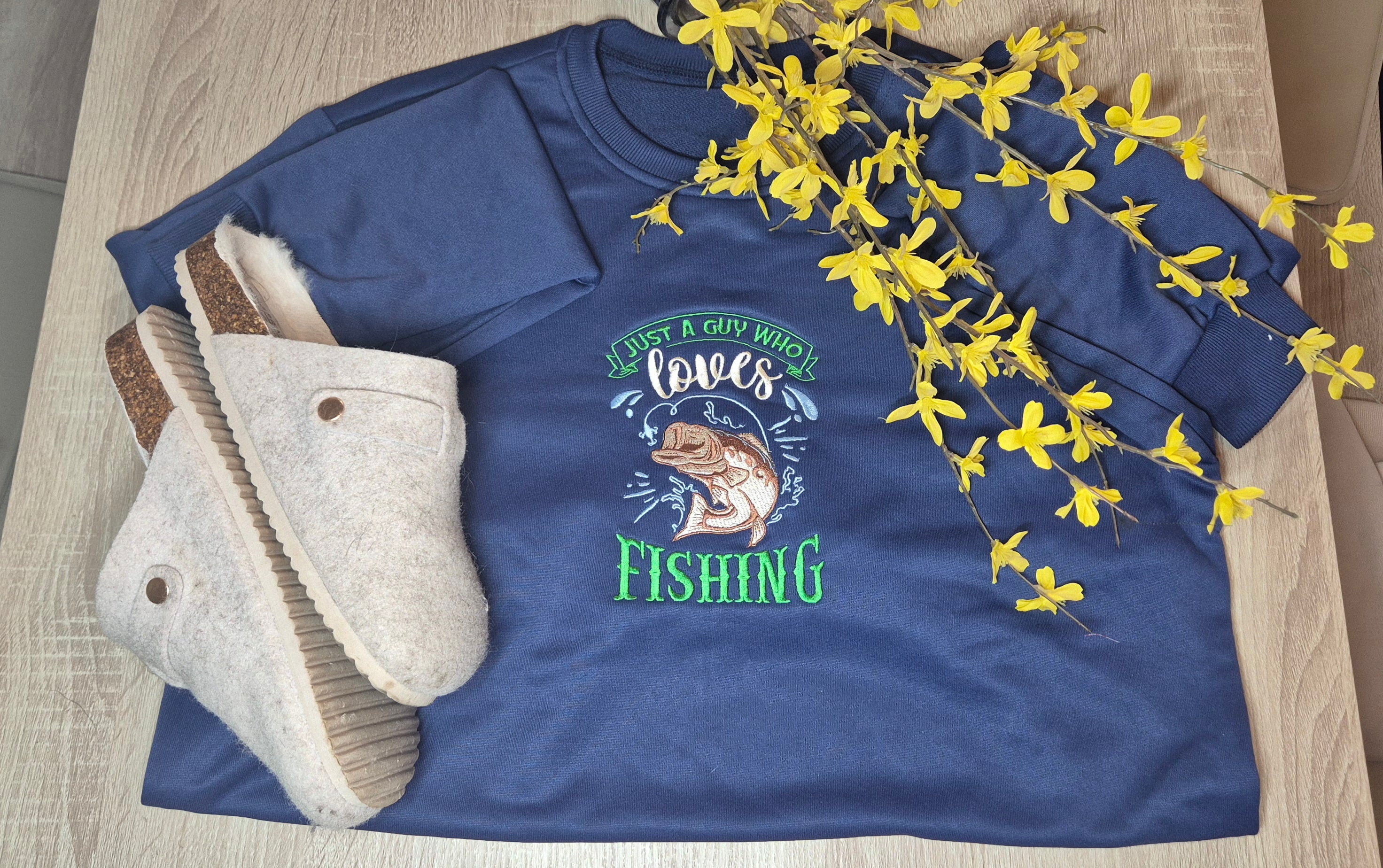 Blue t-shirt with fishing graphic and text