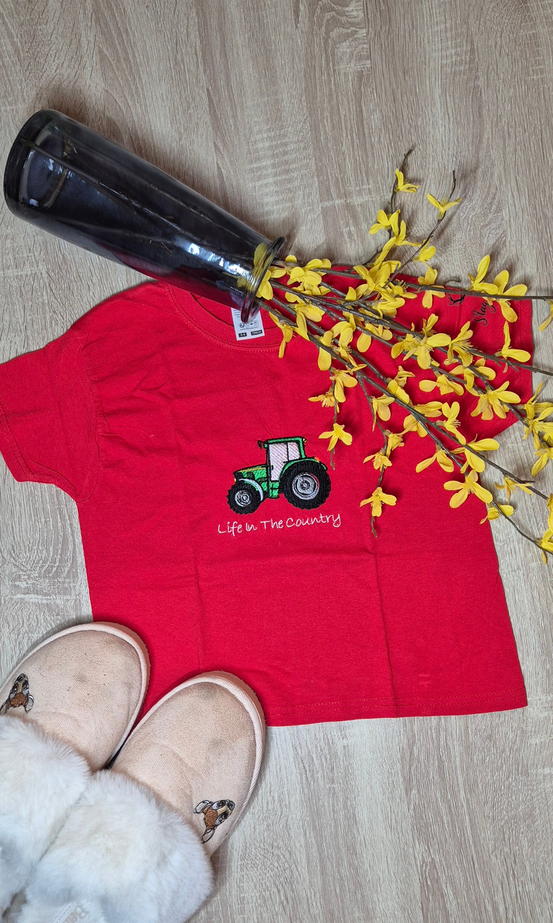 Red t-shirt with a tractor design embroidery