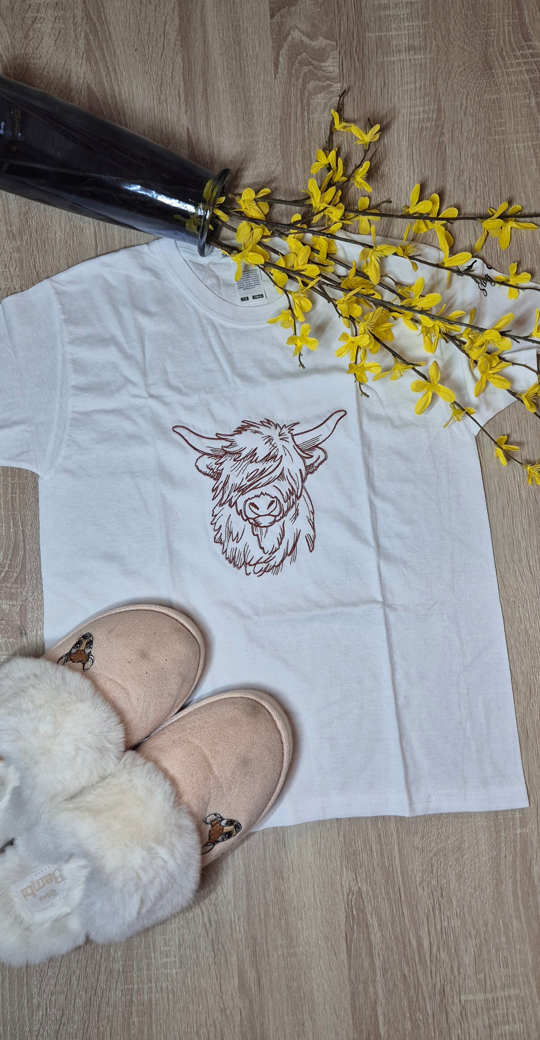 White t-shirt with a highland cow design